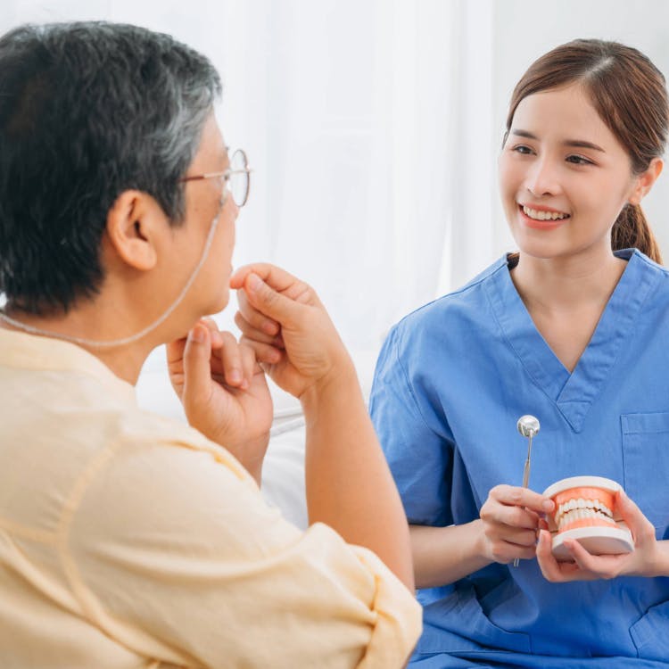Dental professional and a patient speaking to each other during a patient visit