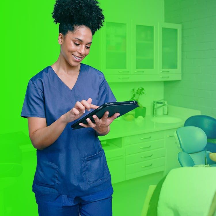 Image of hygienist in office looking at digital device
