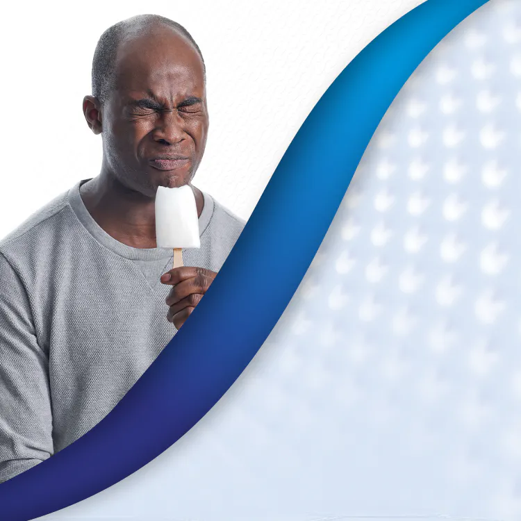 Man with popsicle flinching with header Dentin Hypersensitivity