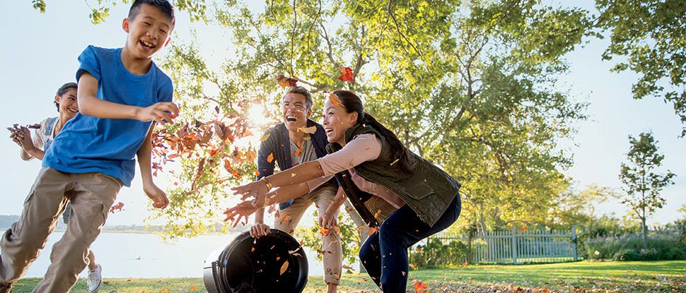 Family playing with leaves