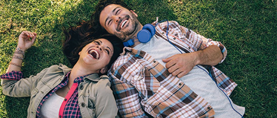 Couple laying on grass