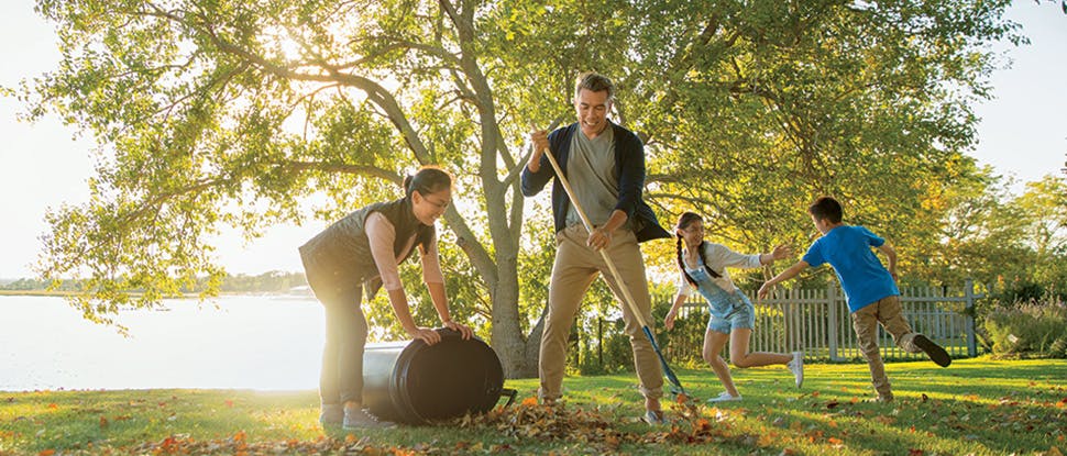 Family raking leaves