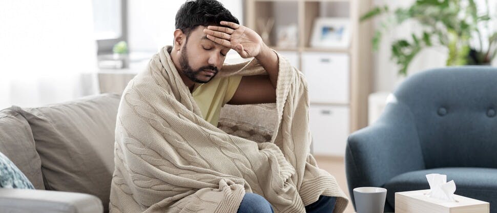 Man sick at home with cold and flu symptoms