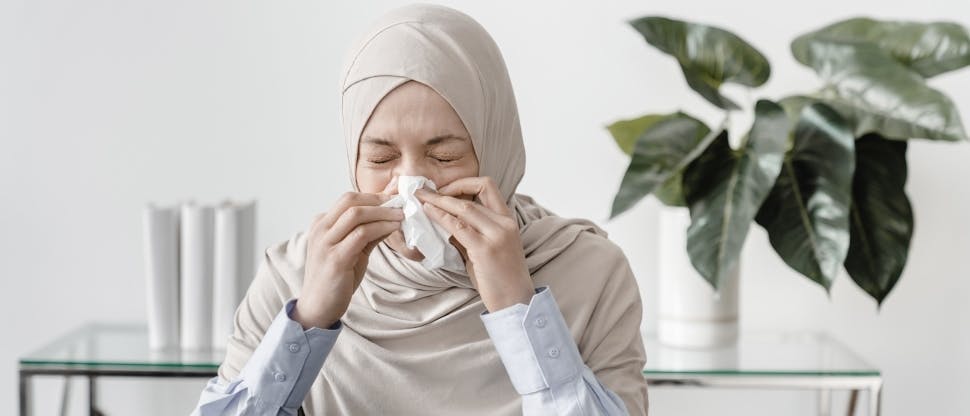 Woman sneezing