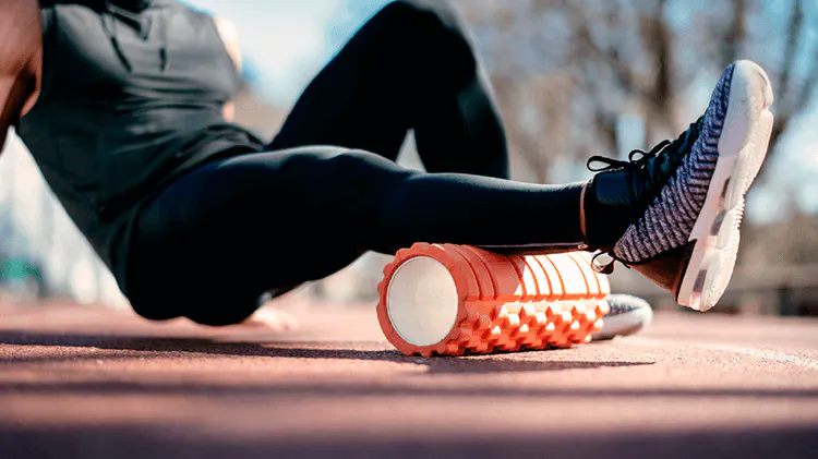 Image of someone using a roller to help manage musculoskeletal pain in their lower leg