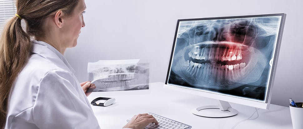 958332936 Dentist at desk