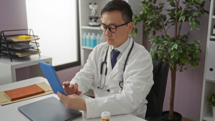 Medical professional writing at desk