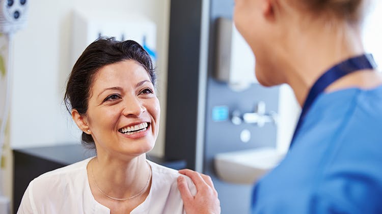 Doctor and patient smiling during appointment