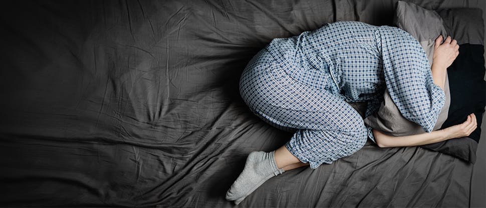 Woman in bed in pain