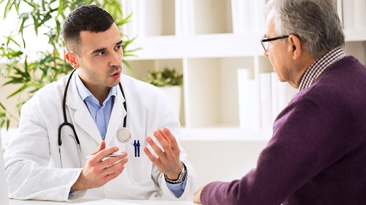 Man discussing with physician