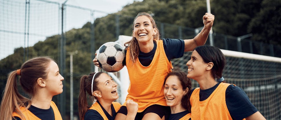Female athletes celebrating at a soccer game
