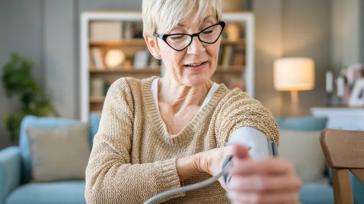 Healthcare worker measuring blood pressure in a clinical setting