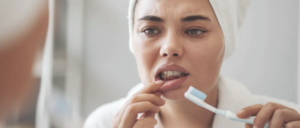 Close-up of a person pulling their lip down to reveal inflamed gums