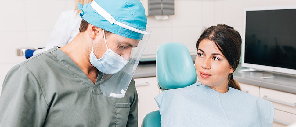 Dentist with senior patient