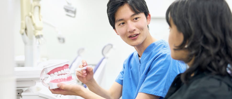 Dentist talking to patient during an office visit