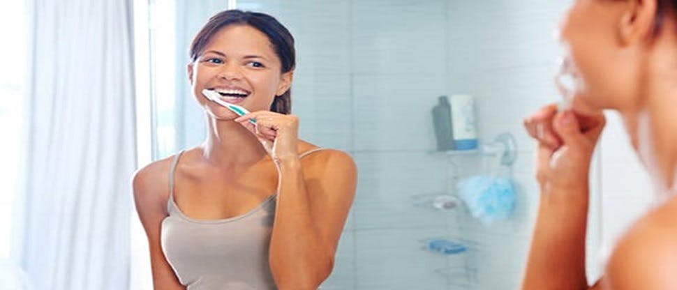 Women brushing teeth