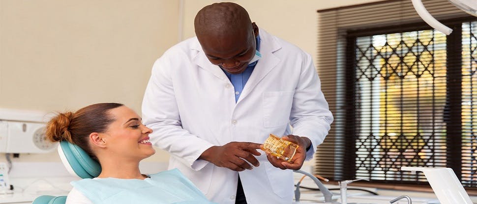 Dentist with patient discussing