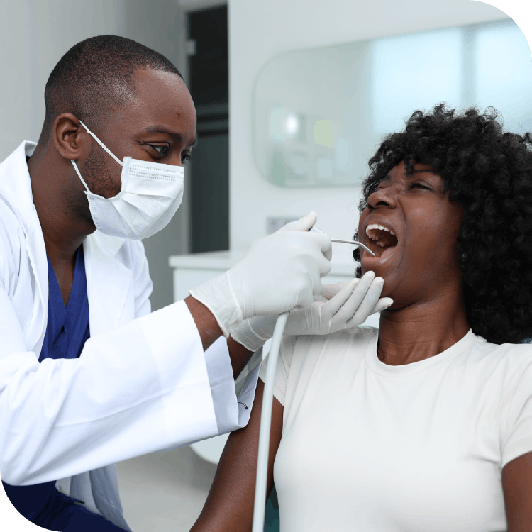 Dr Arnold, UK Dentist, using air probe on patient
