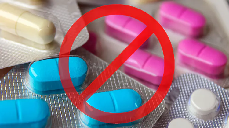 Different antibiotics of varying shape and colours are shown with a prohibition sign over the top.