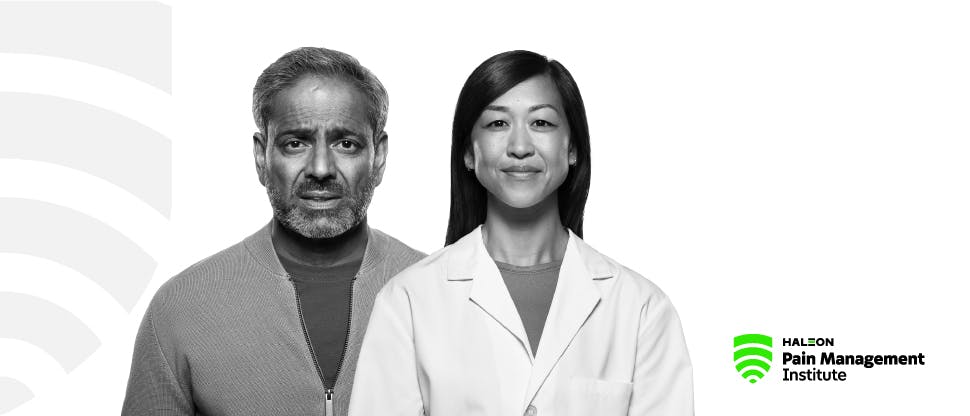 Imagem de um homem mais velho com expressão de dor ao lado de uma médica jovem