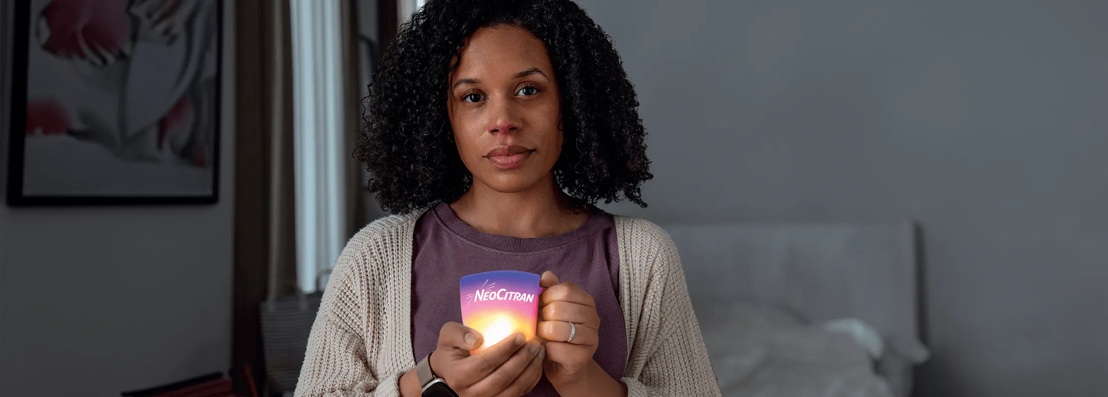 Woman with a cold holding a soothing cup of NeoCitran