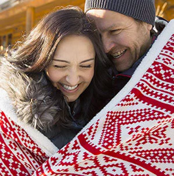 Couple sharing a warm blanket