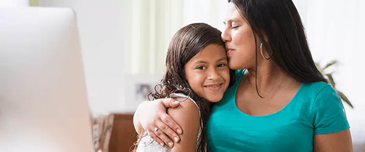 Woman kissing her daughter