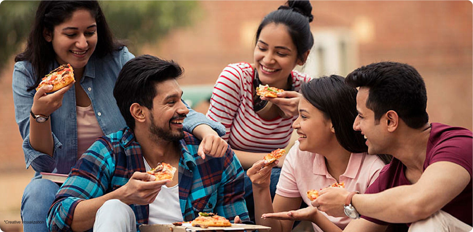 Young group of friends laughing and eating pizza
