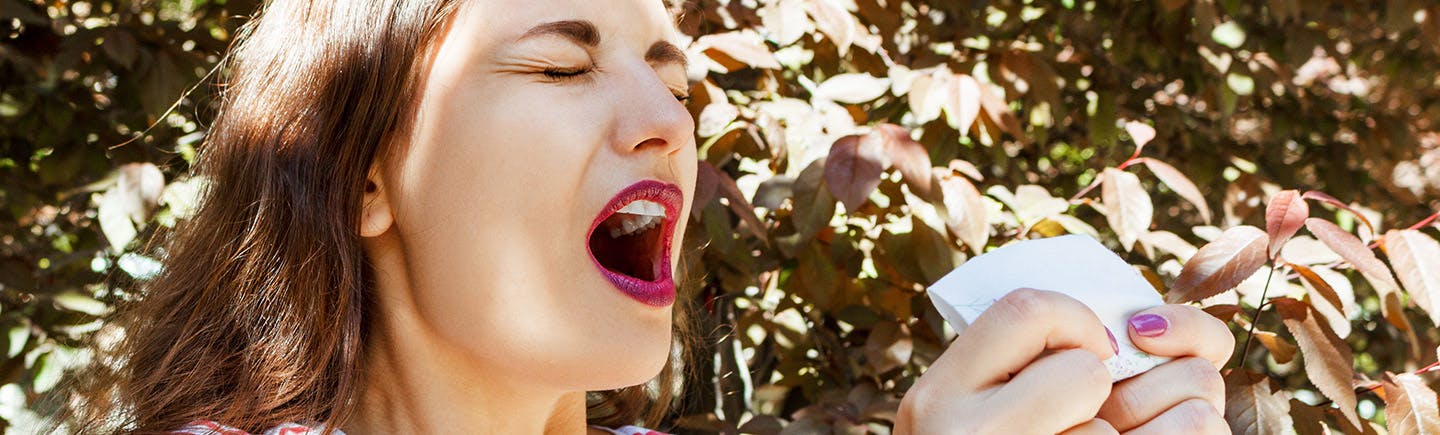 Woman rubs her nose that might be a symptom of sinusitis.