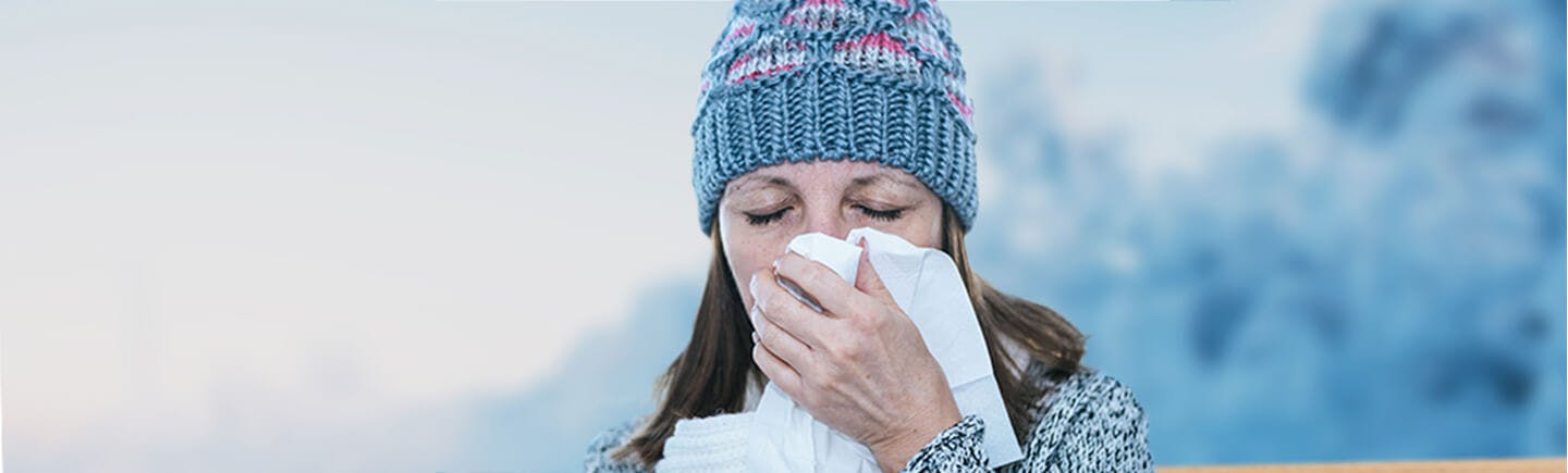 Young woman points to her nose, an organ  of the respiratory system that helps you breathe by filtering impurities from the air.