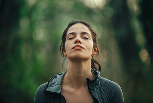 Woman breathes freely in a forest with a decongested nose. Woman breathes freely in a forest with a decongested nose.