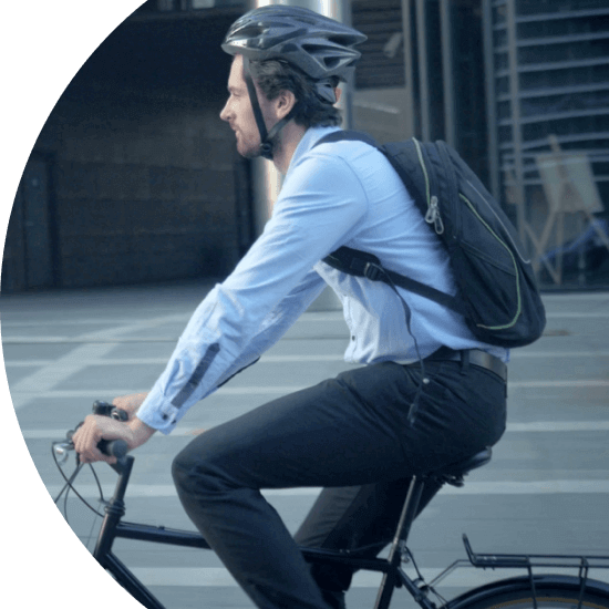 Man commuting to work through a city on a bicycle