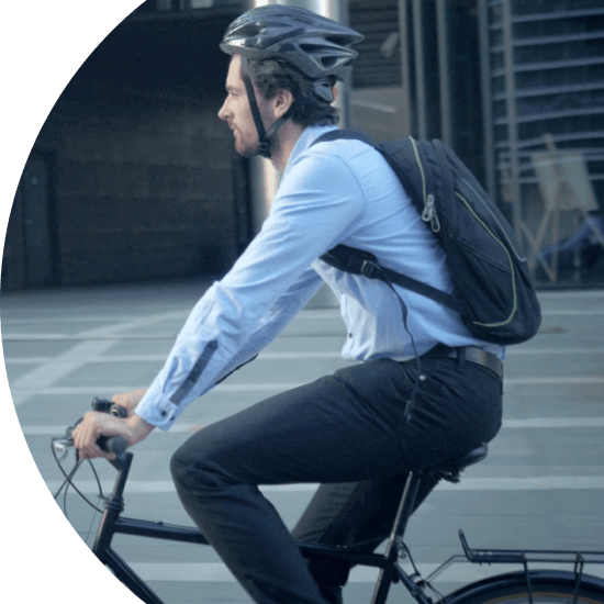 Man commuting to work through a city on a bicycle 