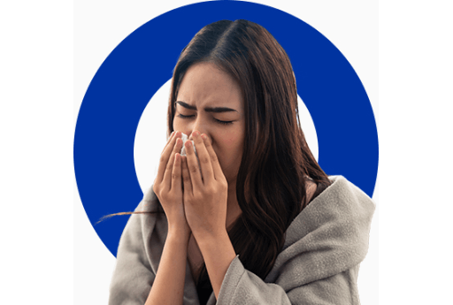 Woman blows her nose which can be a symptom of a cold, flu or allergies such as hay fever.