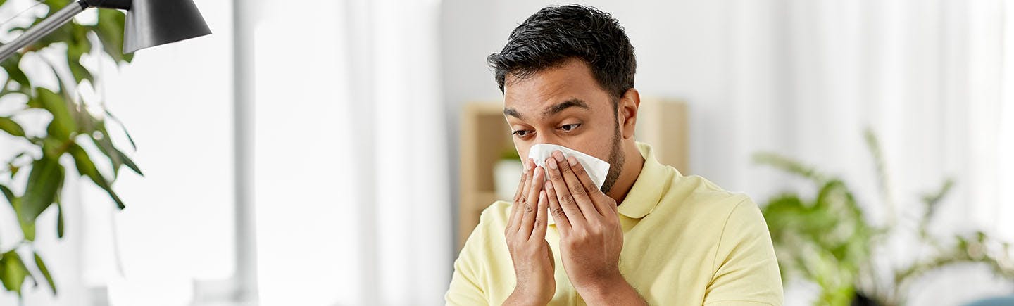 Woman rubs her nose that might be a symptom of sinusitis.