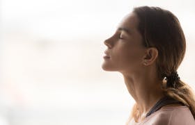 Young woman points to her nose, an organ  of the respiratory system that helps you breathe by filtering impurities from the air.