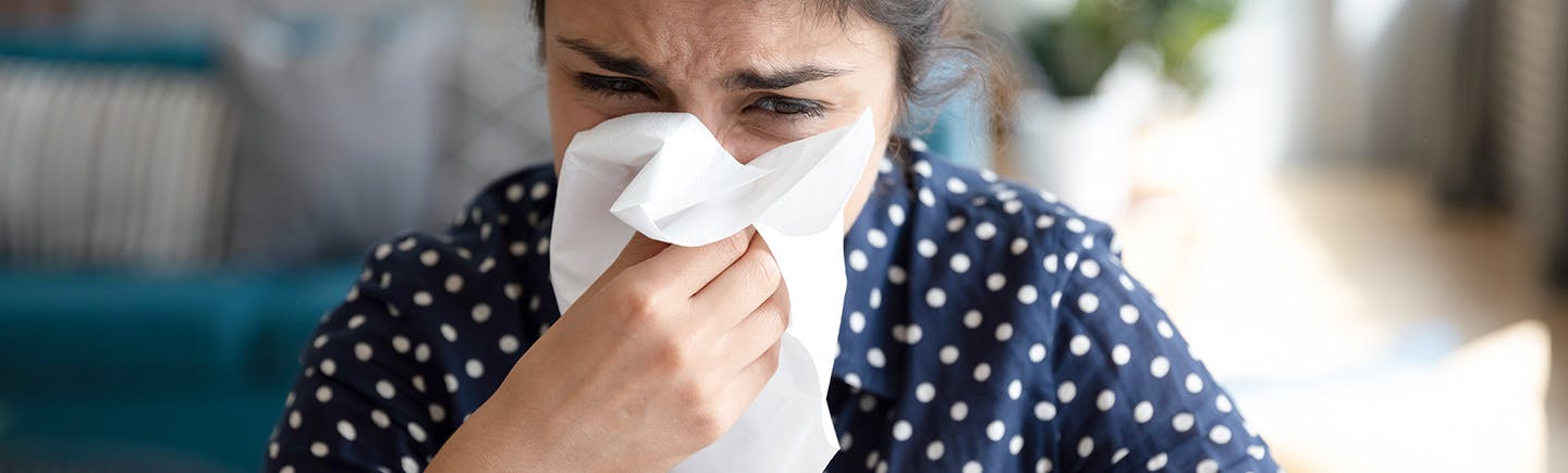 Mature Woman rubs her nose for persistent congestion symptoms.