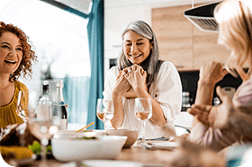 Happy women smiling while eating lunch