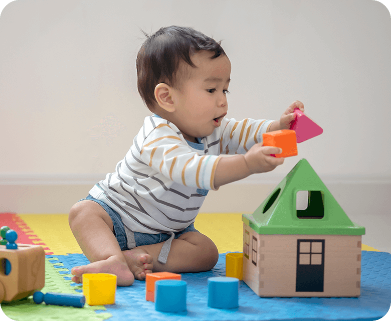 Young father playing with his daughter inside with toys