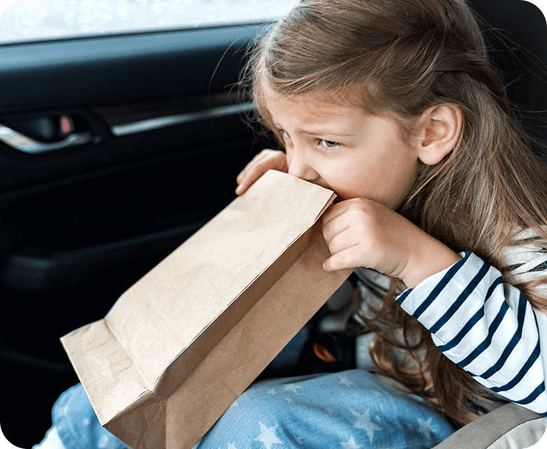 Little girl feeling nauseous while driving in car