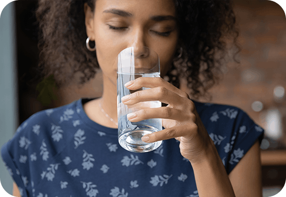 Young woman drinking water from a glass