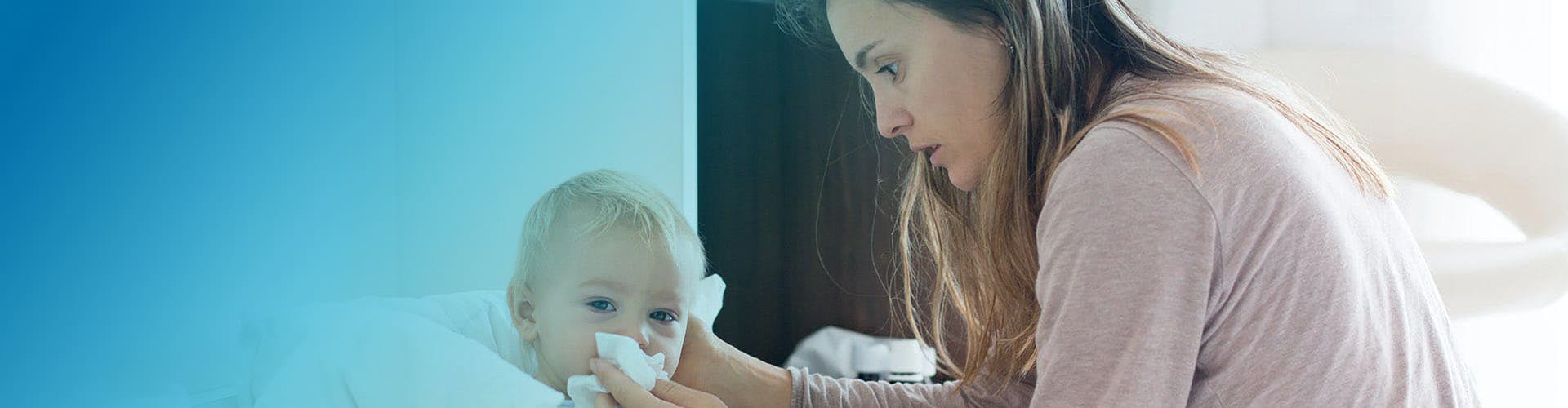 Mother claening her son's nose.