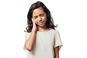 Girl holding her ear in pain