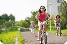 Girl riding a bike with friends