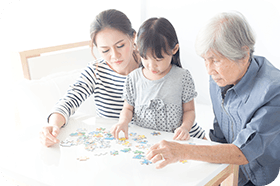 Asian family playing with puzzles