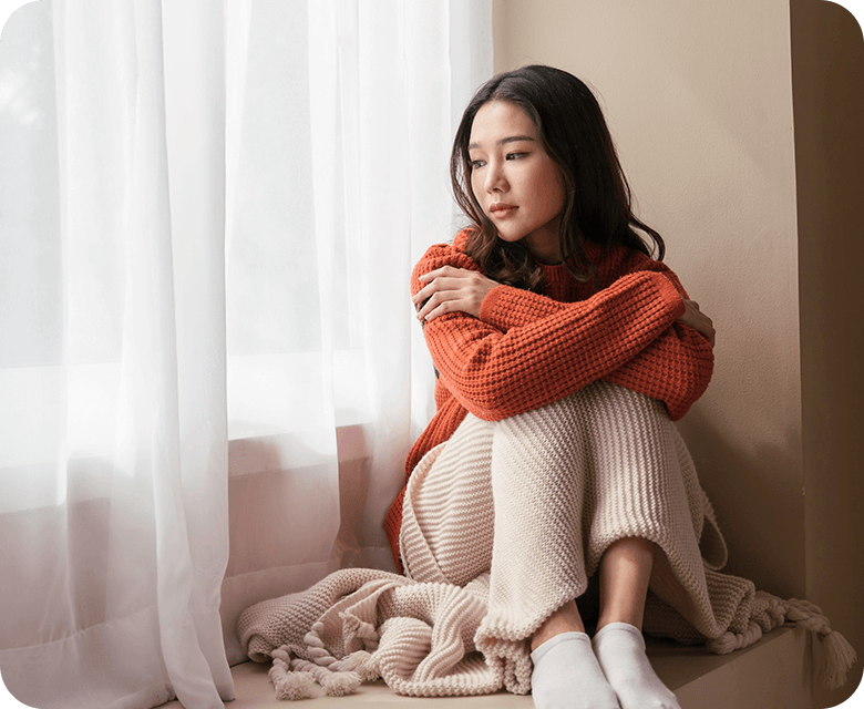 beautiful young asian woman sitting by the window