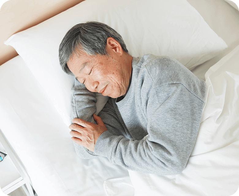 Asian senior man lying in the bed