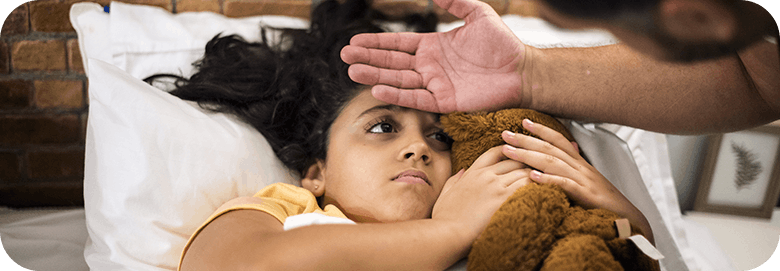 Sick Child Holding Teddy Bear While Her Temperature Is Being Taken By Hand