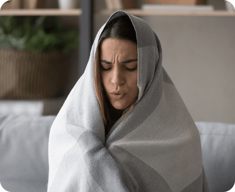 Woman With Fever Symptoms Getting Warmed Up With Blanket