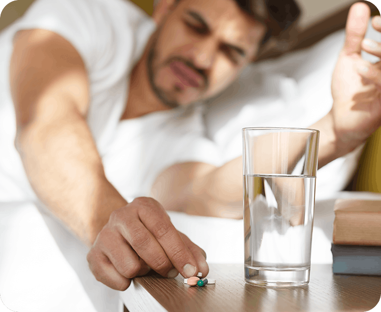 Man Experiencing Pain Taking Panadol Tablets